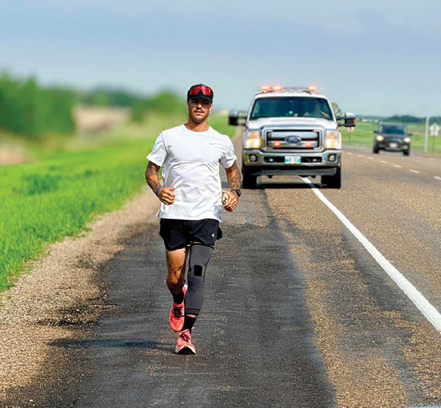 Carter Armstrong on the Trans-Canada Highway between Moosomin and Elkhorn with an escort from the Moosomin Fire Department.